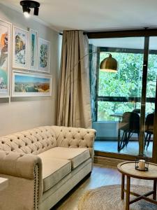 a living room with a couch and a window at Lago y Volcán in Pucón