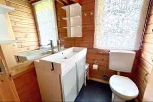 a bathroom with a white sink and a toilet at Ferienhaus Neckar 58 in Hayingen +13 photos