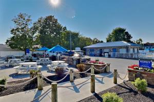 a patio with tables and umbrellas in a parking lot at Put-in-Bay Waterfront Condo #111 in Put-in-Bay
