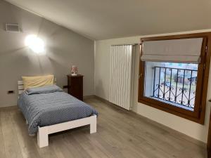 a bedroom with a bed and a window at Villa Santa Maria in Lovero Valtellino