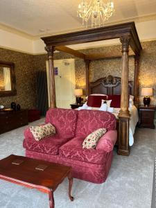 a living room with a couch and a bed at Vomero Holiday Apartments in Torquay +261 photos