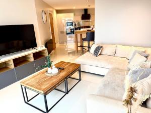 a living room with a couch and a coffee table at Luxe Cardiff Centre Apartment Free Parking in Cardiff