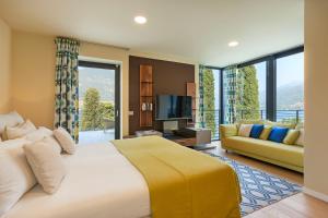 a bedroom with a large bed and a couch at Villa Felicity by My Villa Collection in Riva