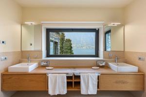 a bathroom with two sinks and a large window at Villa Felicity by My Villa Collection in Riva +35 photos