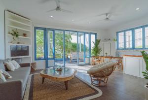 a living room with a couch and a table at Pipeline - Breezy 1 Bedroom Oceanfront Apartment by Triang Villas in Tanah Lot +15 photos