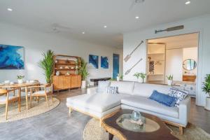 a living room with a couch and a table at Pavones - Tropical Oceanfront 1 Bedroom Apartment by Triang Villas in Tanah Lot +14 photos