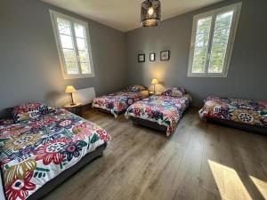 a room with three beds in a room with windows at Cante alaoude in Linxe +25 photos