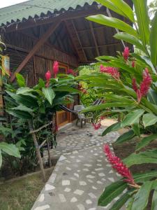 a pathway leading to a house with pink flowers at Casa kumake tayrona in El Zaino +85 photos