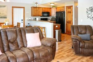a living room with a couch and two chairs at BOHO Bungalow on the Pond w/ Hot Tub in Arnolds Park