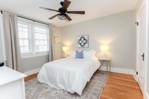 a bedroom with a white bed and a ceiling fan at Sojourn at Colley Manor Unit 5 in Norfolk