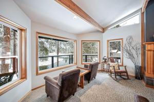 a home office with a table and chairs and windows at All Seasons River Inn in Leavenworth
