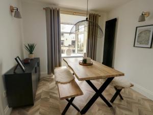 a dining room with a wooden table and chairs at 1 Mona Terrace in Holyhead