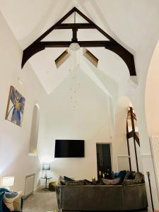 a living room with a couch and a ceiling at The Bell Tower in Bonnybridge