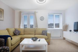 a living room with a couch and a coffee table at New! Spacious Retreat for 10 Perfect for Families! in Bowburn