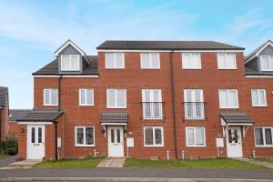 an empty red brick building with white windows at New! Spacious Retreat for 10 Perfect for Families! in Bowburn