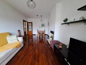 a living room with a couch and a table at Comfortable & central apartment in Senhora da Hora
