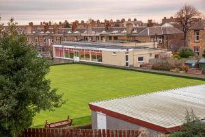 a large green lawn in front of a building at Sailte House in Edinburgh