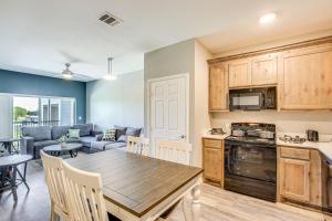 a kitchen and living room with a wooden table and chairs at Close to Lakes, Parks and Winery Bonham Apt in Bonham