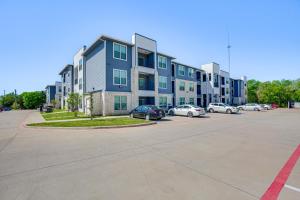 a large building with cars parked in a parking lot at Close to Lakes, Parks and Winery Bonham Apt in Bonham