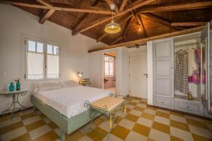 a bedroom with a bed and a checkered floor at Ermioni Villa in Tsilivi