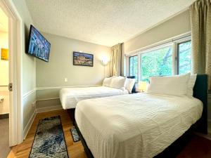 a hotel room with two beds and a window at The GEM Museum Suites in Evanston +62 photos