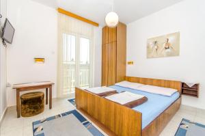 Postel nebo postele na pokoji v ubytování Apartmani Smiljana