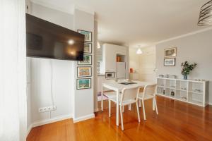 a dining room with a white table and chairs at Espinho Seawalk and Seaview by Vacationy in Porto
