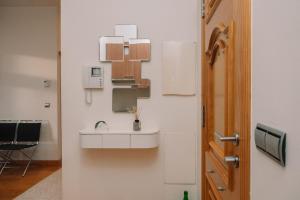 a bathroom with a sink next to a door at Céntrico con vistas a la ría by CABANA Rentals in Vigo +26 photos