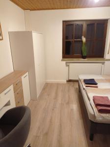 an empty room with a bed and a window at Geräumige Ferienwohnung 90 sqm im Erholungsort in Bestwig