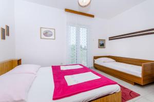 Postel nebo postele na pokoji v ubytování Apartmani Smiljana