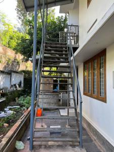 a set of stairs leading up to a building at Safari Homestay, Malayattoor in Kodanad