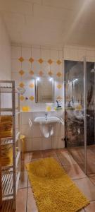 ein Badezimmer mit Waschbecken und Spiegel in der Unterkunft Gartenwohnung in Norden