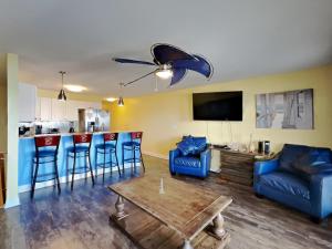 a living room with a couch and a table at Put-In-Bay Waterfront Condo #108 in Put-in-Bay
