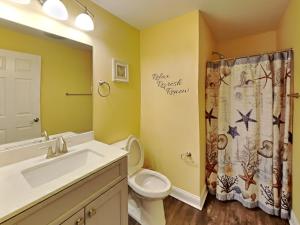a bathroom with a sink toilet and a shower curtain at Put-In-Bay Waterfront Condo #108 in Put-in-Bay