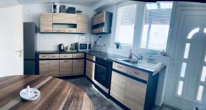 a kitchen with wooden cabinets and a wooden table at Oberbaselweg in Weil am Rhein