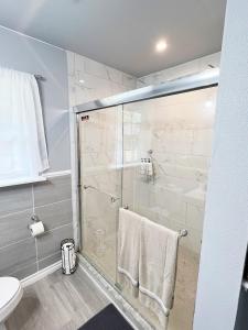 a bathroom with a glass shower and a toilet at Old Oak Ranch in Cameron +53 photos