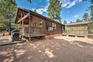 a log cabin with a deck and a grill at Pet Friendly Retreat in Rim Country! With a Spa! in Mogollon Airpark