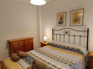 a bedroom with a bed with two pillows on it at Bahia de Vera Apartamento Jazmin in Playas de Vera +37 photos