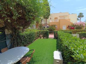 a garden with a table and chairs and a lawn at Bahia de Vera Apartamento Jazmin in Playas de Vera