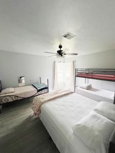a bedroom with two beds and a ceiling fan at Old Oak Ranch in Cameron
