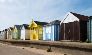a row of colorful beach huts on a sidewalk at Buzzard Barn in Lincoln