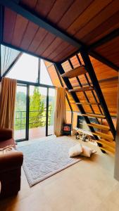 a large living room with a couch and large windows at Casa Girassol in Teresópolis
