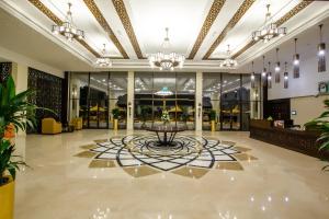 a lobby with a fountain in the middle of a building at Western Hotel - Madinat Zayed in Madīnat Zāyid