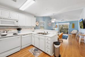 a kitchen with white cabinets and a sink at 53E Bayside Birdie condo in Pawleys Island