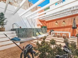 a hammock in a house with a patio at Portugal Secret by CORAL - Townhouse with small pool in Portimão