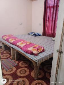 a bed in a room with a blanket on it at Mahavir home stay in Prayagraj