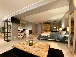 a bedroom with a bed and a table in a room at Le Nid à Bulles Scandinave in Vernon