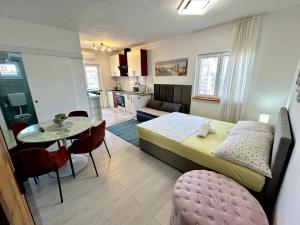 a bedroom with a bed and a table and a kitchen at Villa Daja in Biograd na Moru