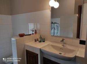 a bathroom with a sink and a mirror at Bed and Breakfast CASA MANU in Loro Ciuffenna +25 photos
