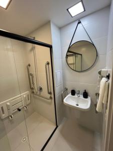 a bathroom with a sink and a mirror and a shower at Studio Moderno ao lado do Metrô Alto da Ipiranga in Sao Paulo +19 photos